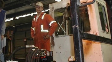 Kraft team member on site beside heavy equipment